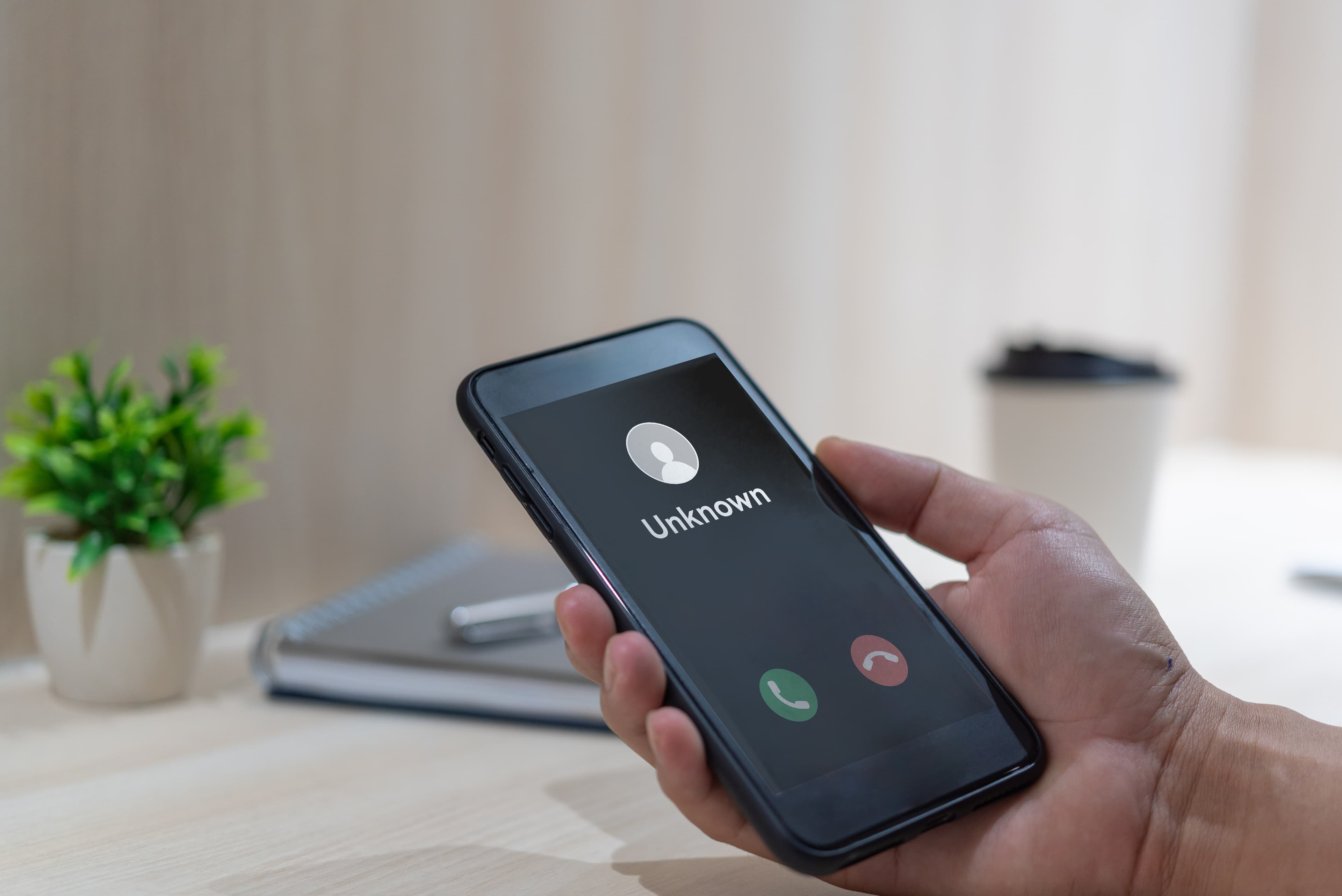 AI receptionist screening spam callers on mobile phone.